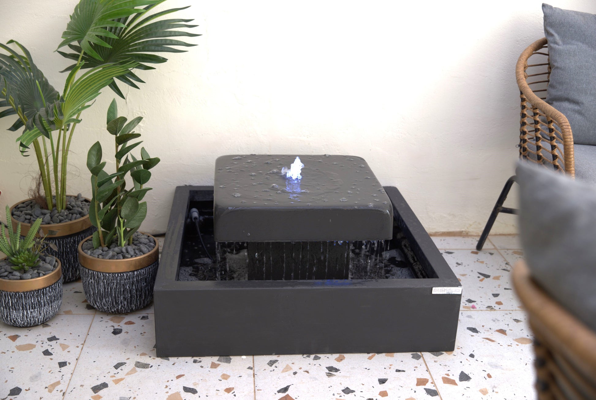 نافورة كونكريت مربعة بسطح مائي هادئ تناسب الحدائق